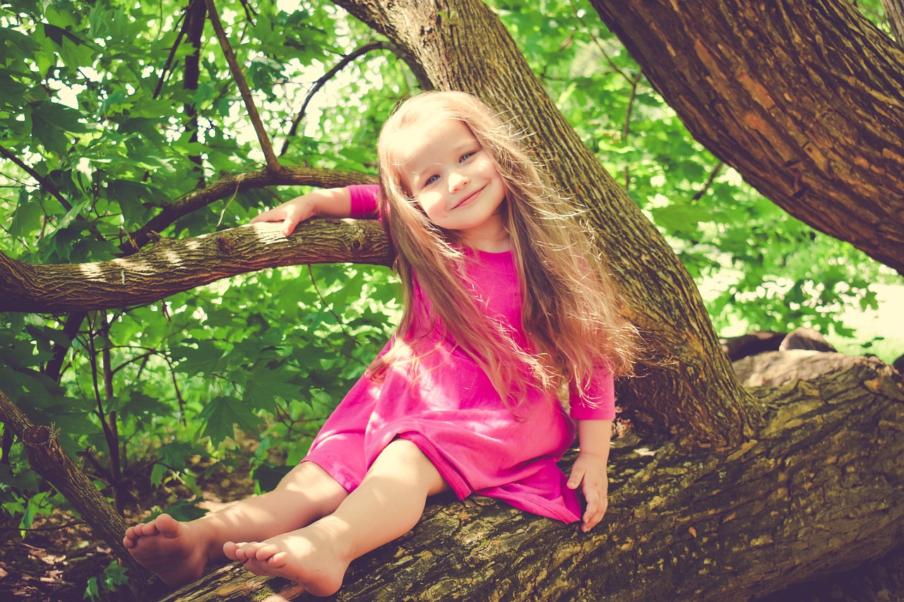 Child Speech Therapy Patient Playing In A Tree During The Summer