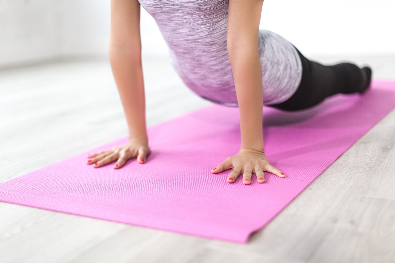 woman with new health goals doing yoga